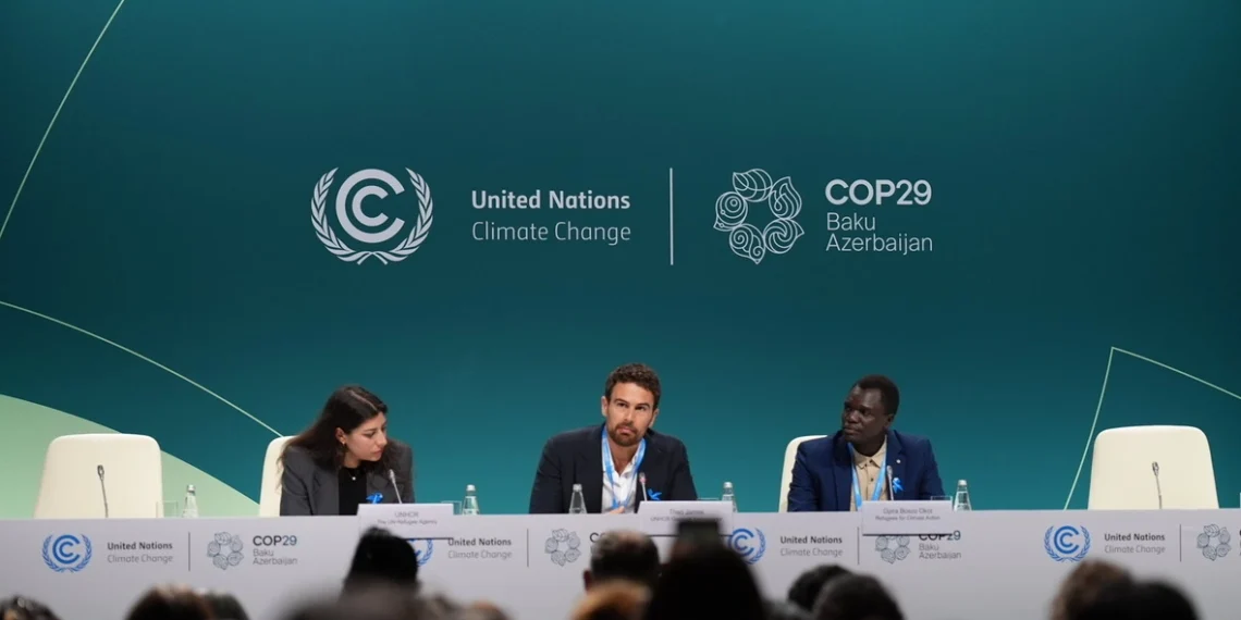 Actor and UNHCR Goodwill Ambassador Theo James (centre) and refugee climate activist Opira Bosco Okot (right) at the launch of the "Refugees for Climate Action" network at COP29 on Thursday.