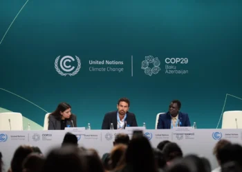 Actor and UNHCR Goodwill Ambassador Theo James (centre) and refugee climate activist Opira Bosco Okot (right) at the launch of the "Refugees for Climate Action" network at COP29 on Thursday.
