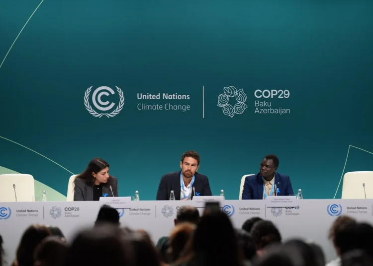 Actor and UNHCR Goodwill Ambassador Theo James (centre) and refugee climate activist Opira Bosco Okot (right) at the launch of the "Refugees for Climate Action" network at COP29 on Thursday.